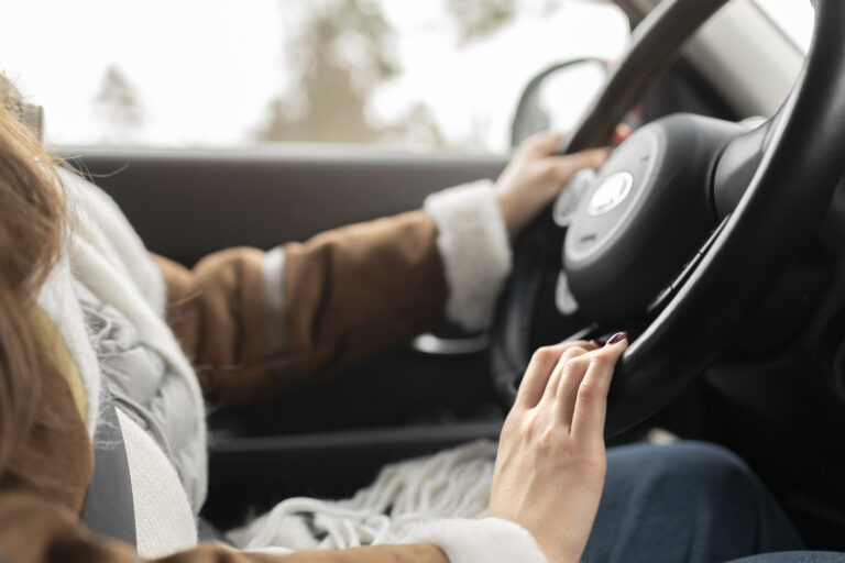 Side view of a woman driving a car