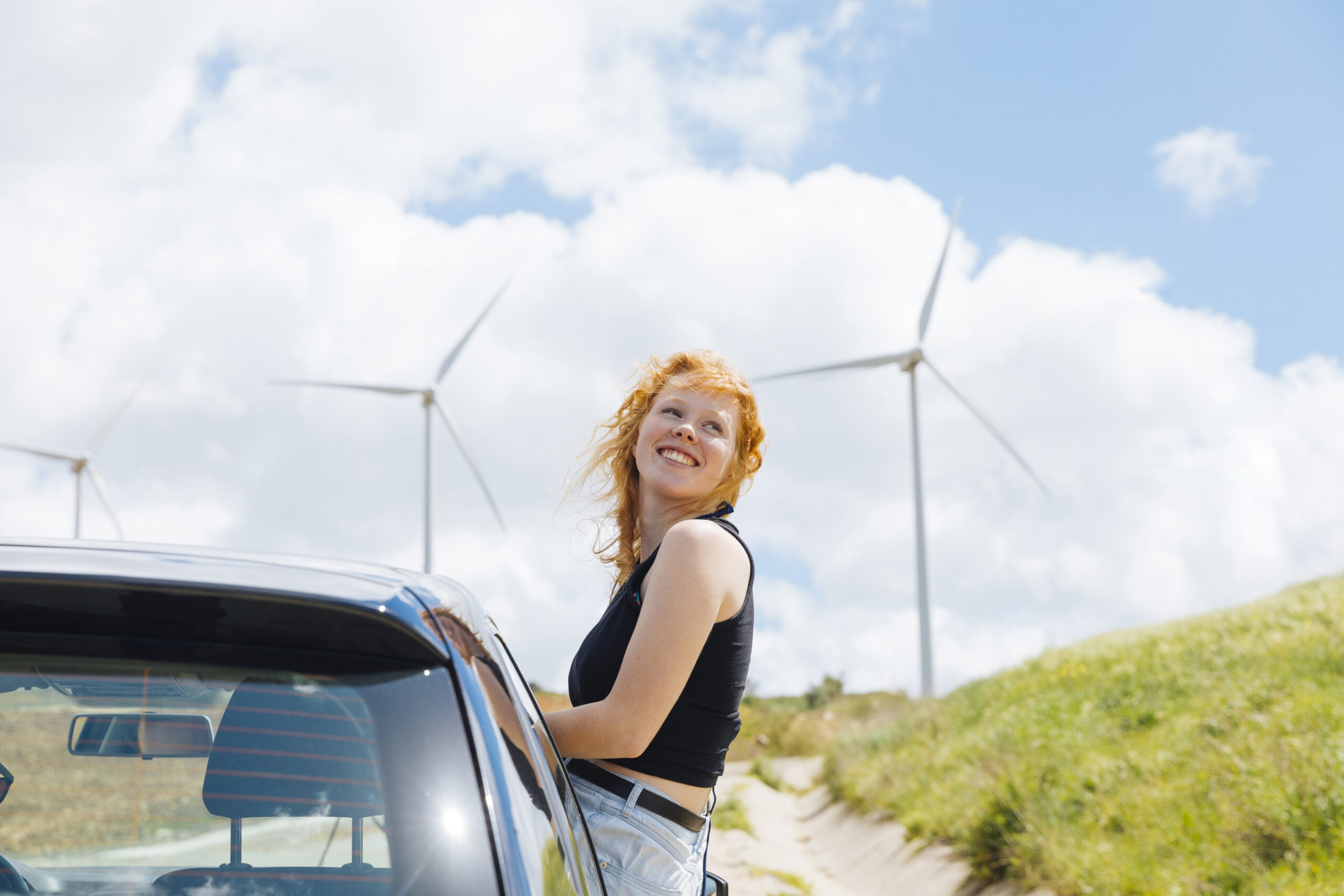 woman looking around out car window
